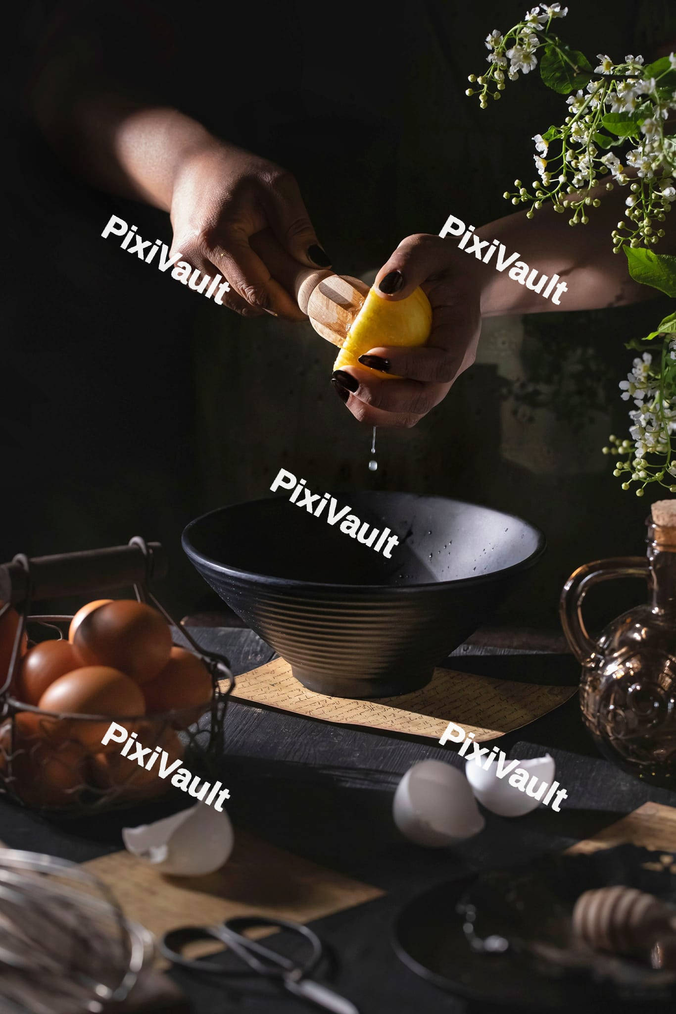 A woman squeezing lemon into a bowl
